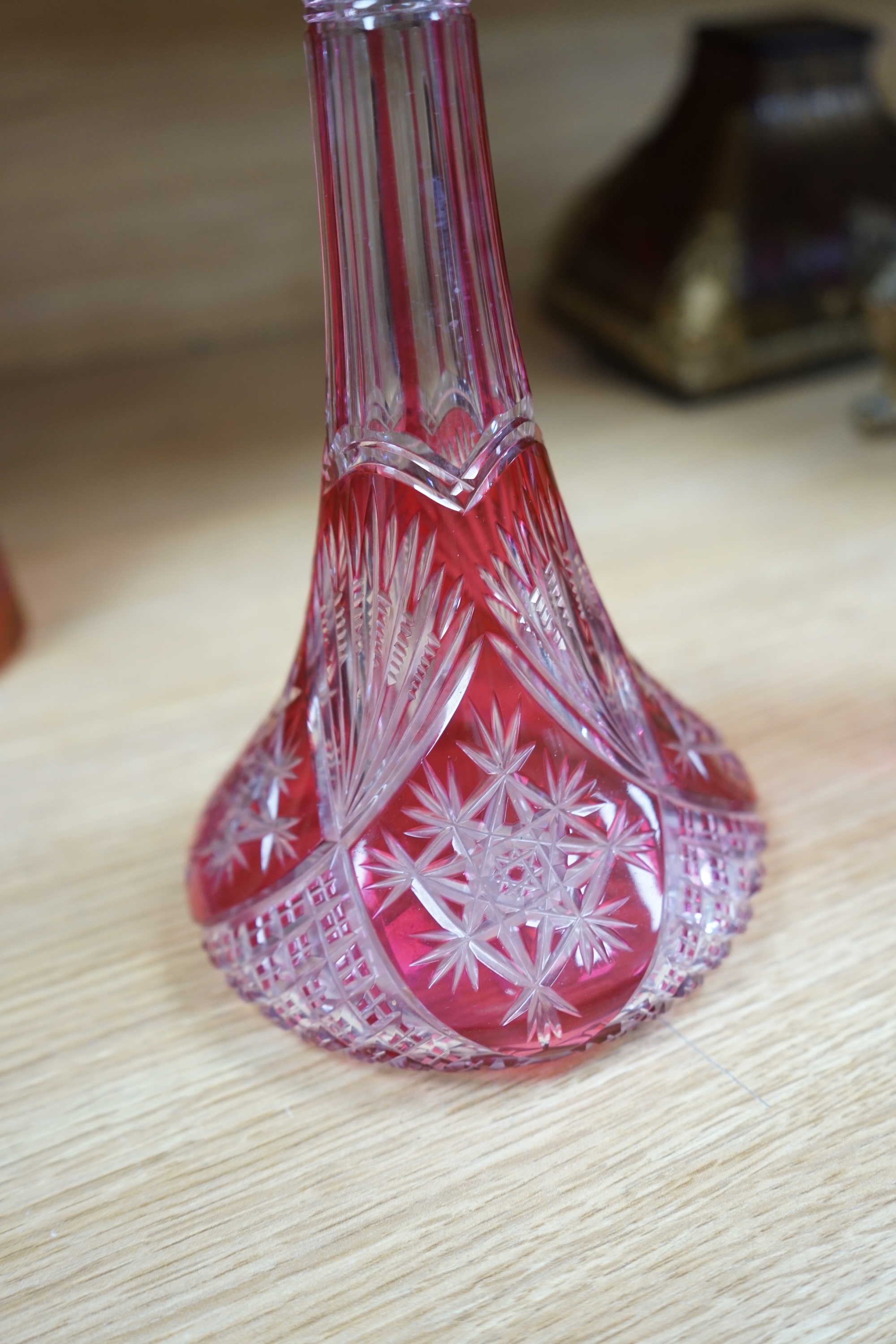 A collection of cranberry glassware comprising three decanters with stoppers and a silver plate mounted ewer, largest 41cm high. Condition - fair to good